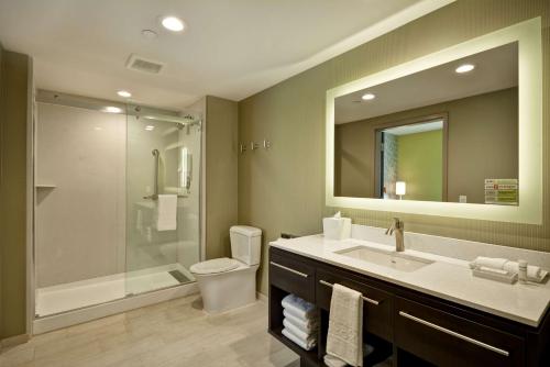 a bathroom with a toilet and a sink and a shower at Home2 Suites By Hilton Hanford Lemoore in Hanford
