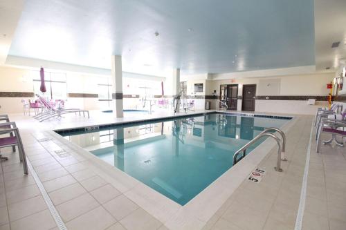 a large swimming pool with blue water in a building at Hampton Inn and Suites Sandusky/Milan in Milan