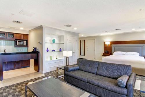 a living room with a couch and a bed at DoubleTree by Hilton Toronto Downtown in Toronto