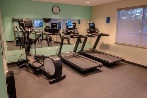 a gym with several exercise bikes and cell phones at Tru By Hilton Norfolk Airport, Va in Virginia Beach