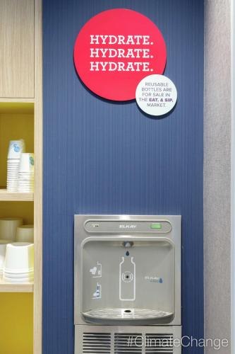 a sign on a wall above a hyperadobeadobegraduategraduate inverarial at Tru By Hilton Frisco Dallas, Tx in Frisco