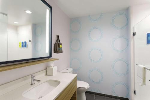 a bathroom with a sink and a toilet and a mirror at Tru By Hilton Frisco Dallas, Tx in Frisco