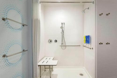 a white bathroom with a shower and a sink at Tru By Hilton Frisco Dallas, Tx in Frisco