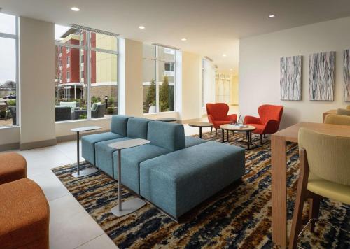 a living room with a blue couch and chairs at Hilton Garden Inn Olive Branch, Ms in Olive Branch