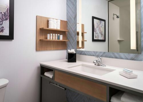 a bathroom with a sink and a mirror at Hilton Garden Inn Olive Branch, Ms in Olive Branch