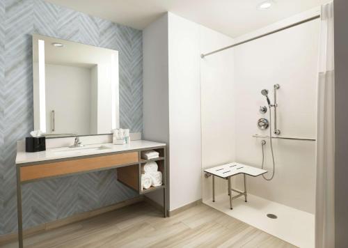 a bathroom with a sink and a shower at Hilton Garden Inn Olive Branch, Ms in Olive Branch