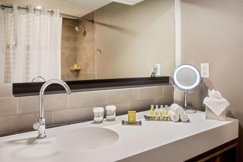 a bathroom with a sink and a mirror at DoubleTree by Hilton Atlanta Northwest/Marietta in Atlanta