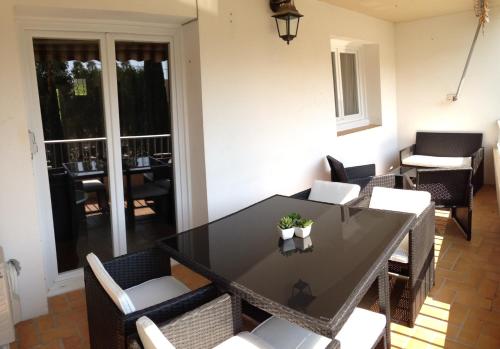 a dining room with a black table and chairs at Le Diodon De Sagone in Sagone