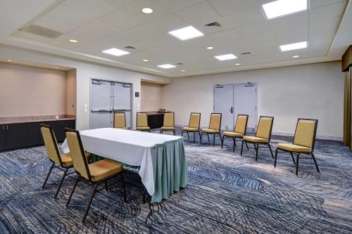 a conference room with a table and chairs at Hilton Garden Inn Fort Myers in Fort Myers