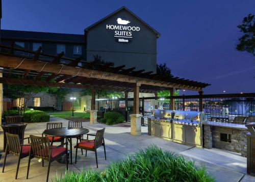 a patio with a table and chairs in front of a building at Homewood Suites by Hilton Waco in Waco