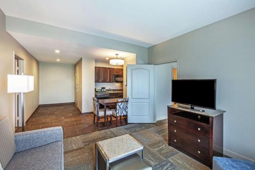 a living room with a flat screen tv and a couch at Homewood Suites by Hilton Waco in Waco