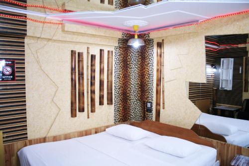 Postel nebo postele na pokoji v ubytování Mamba Hotel