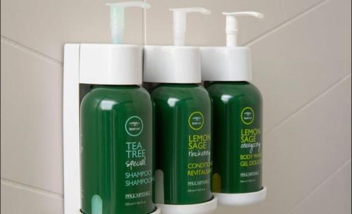 a group of three bottles of green liquid on a shelf at Fairfield Inn by Marriott Tracy in Tracy