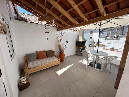 a living room with a couch and a table at Casinha da Patricia in Nazaré