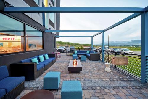 a patio with blue chairs and a table on a building at Tru By Hilton Pigeon Forge in Pigeon Forge