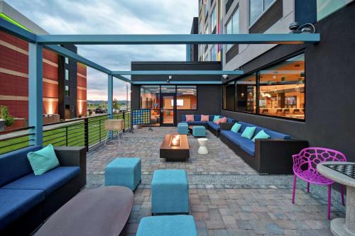 a rooftop patio with couches and tables on a building at Tru By Hilton Pigeon Forge in Pigeon Forge