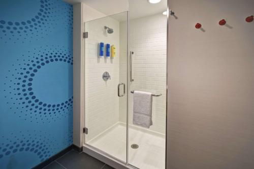 a shower with a glass door in a bathroom at Tru By Hilton Pigeon Forge in Pigeon Forge