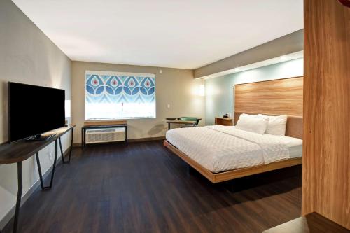 a hotel room with a bed and a flat screen tv at Tru By Hilton Pigeon Forge in Pigeon Forge