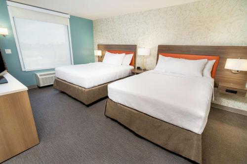 a hotel room with two beds and a window at Home2 Suites By Hilton Roseville Sacramento in Roseville