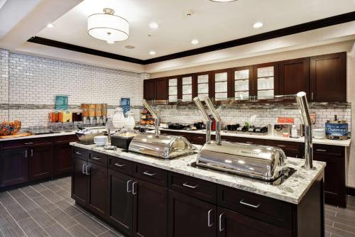 a kitchen with stainless steel pots and pans on a counter at Homewood Suites by Hilton Novi Detroit in Novi