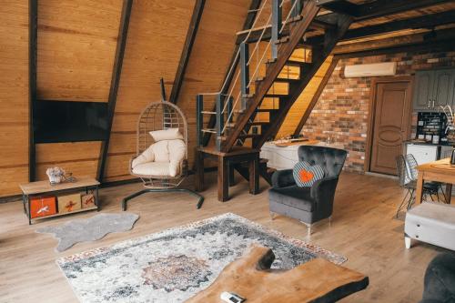 a living room with a staircase and a chair at Greenworldbungalov2 in Sapanca