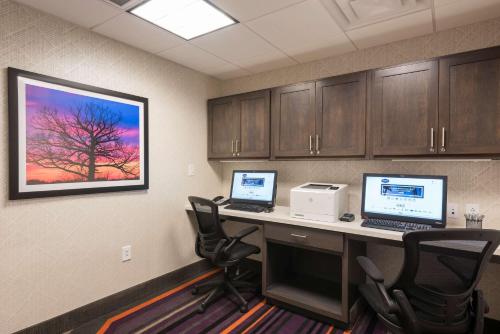 a office with two computers on a desk with chairs at Hampton Inn & Suites West Lafayette, In in West Lafayette