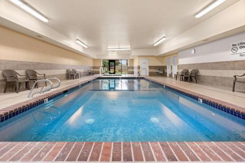 a large swimming pool with blue water in a building at Hampton Inn & Suites Burlington in Burlington