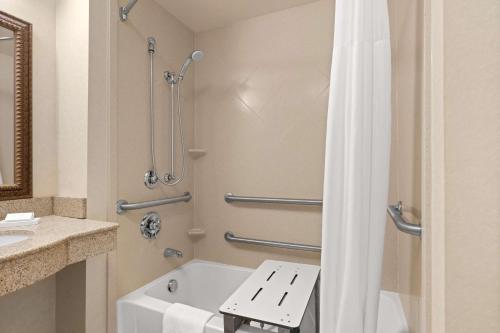 a bathroom with a tub and a sink and a shower at Hampton Inn & Suites Burlington in Burlington