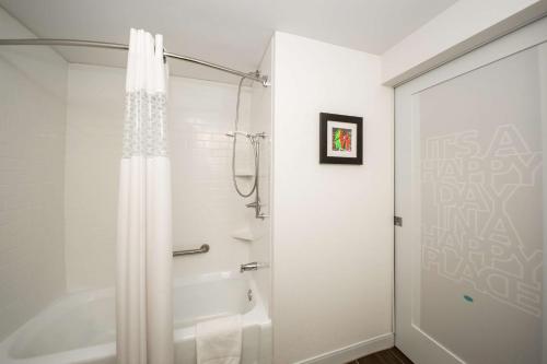 a bathroom with a shower with a shower curtain at Hampton Inn Philadelphia-Airport in Philadelphia
