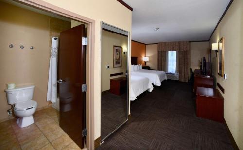 a hotel room with a bed and a toilet at Hampton Inn Seguin in Seguin