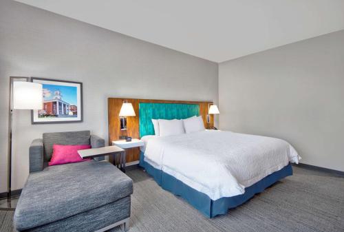 a hotel room with a bed and a chair at Hampton Inn Abingdon, Va in Abingdon