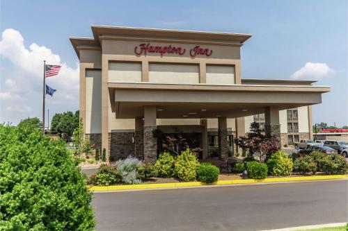 a store front of a shopping center with an american flag at Hampton Inn Winchester-University/ Mall in Winchester