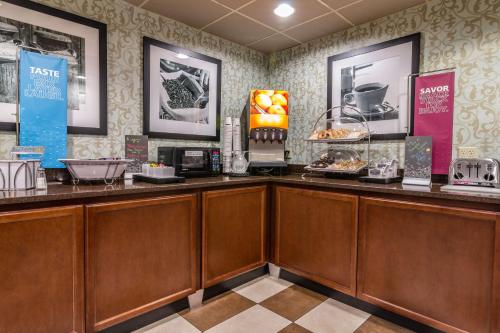 a restaurant with a counter with food on it at Hampton Inn Winchester-University/ Mall in Winchester