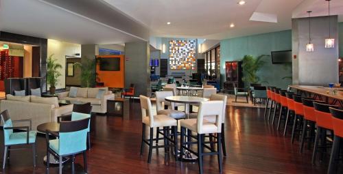 a restaurant with chairs and tables and a bar at DoubleTree by Hilton Hotel Miami Airport & Convention Center in Miami