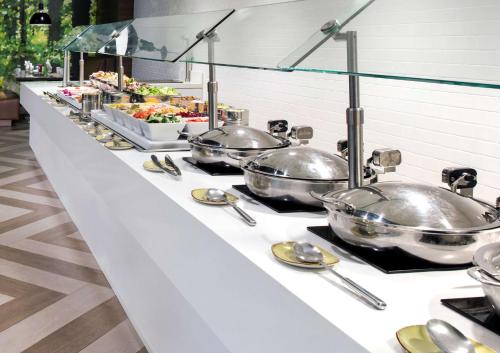 a buffet line with several pots of food on it at DoubleTree by Hilton Hotel Miami Airport & Convention Center in Miami
