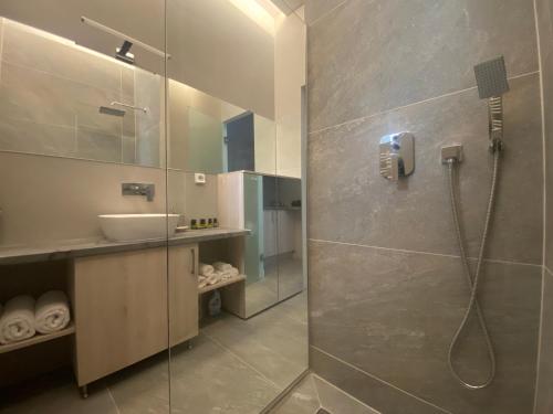 a bathroom with a shower and a sink at Serendipity Living Studio in Kýthira