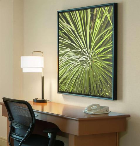 a desk with a lamp and a chair in a hotel room at DoubleTree by Hilton Hotel Miami Airport & Convention Center in Miami