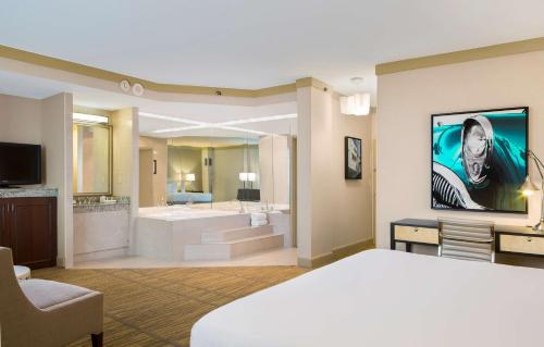 a hotel room with a large bed and a bathroom at DoubleTree by Hilton Hotel Miami Airport & Convention Center in Miami