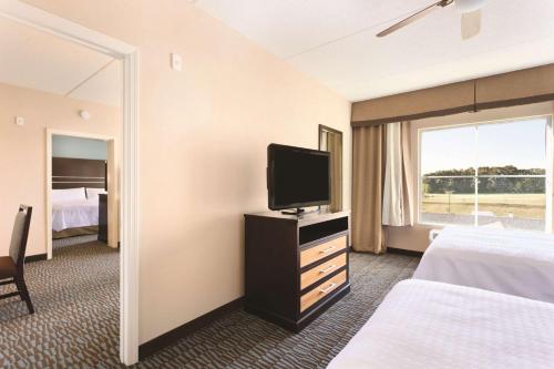 a hotel room with a television and a bed at Homewood Suites Atlanta Airport North in Atlanta