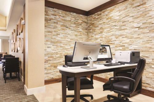 an office with a desk with a computer and chairs at Homewood Suites Atlanta Airport North in Atlanta