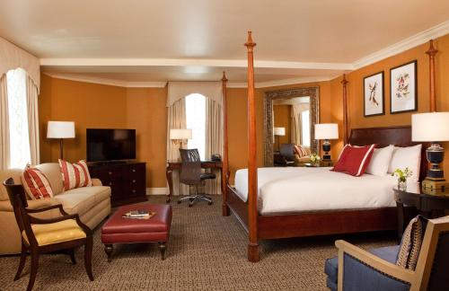a hotel room with a bed and a desk and chair at Hotel Roanoke & Conference Center, Curio Collection by Hilton in Roanoke