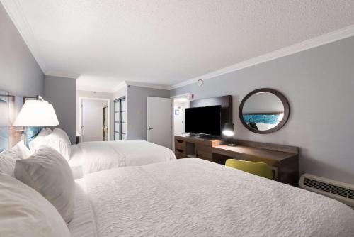 a hotel room with two beds and a television at Hampton Inn & Suites Chicago-Hoffman Estates in Hoffman Estates