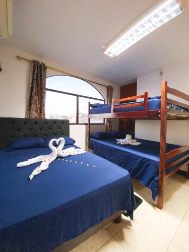 a bedroom with two bunk beds with a ribbon on it at Apartment in San Cristóbal with 2 Bedrooms, 6 Beds, Living Room, Dining Room, Kitchen, Private Balcony, Terrace with Ocean View, Washer, Satellite Internet, Near Bars and Restaurants - Blue Horizon - Galápagos Home in Puerto Baquerizo Moreno