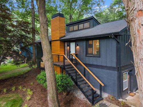 a black and yellow house in the woods at Near Biltmore, Hiking, Breweries W Game Room in Fletcher