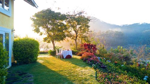 a table in the garden of a house at Binh An Village Resort in Da Lat