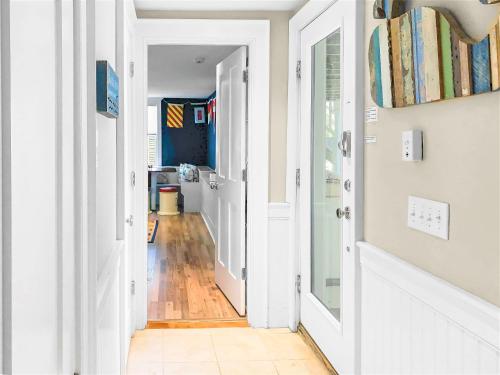 an open hallway with white walls and wood floors at 14 Hallet Lane Chatham Cape Cod - - Sand Simeon in Chatham