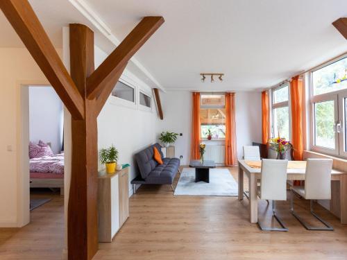 a living room with a table and a dining room at Cosy apartment with sauna in the Black Forest in Sulz am Neckar