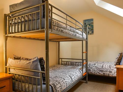 LlanedyにあるLlandremor Fawr Cottageの二段ベッド2組付きの二段ベッド付きの部屋