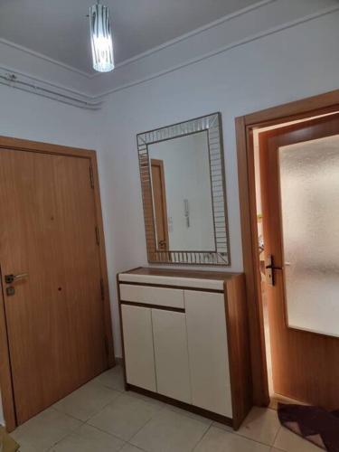 a bathroom with a mirror on the wall and a door at F5 -5 bedrooms Apt- Residence Hasnaoui avec parking Oran Algeria in Oran