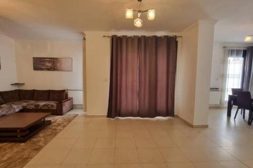 a living room with a couch and a table at F5 -5 bedrooms Apt- Residence Hasnaoui avec parking Oran Algeria in Oran